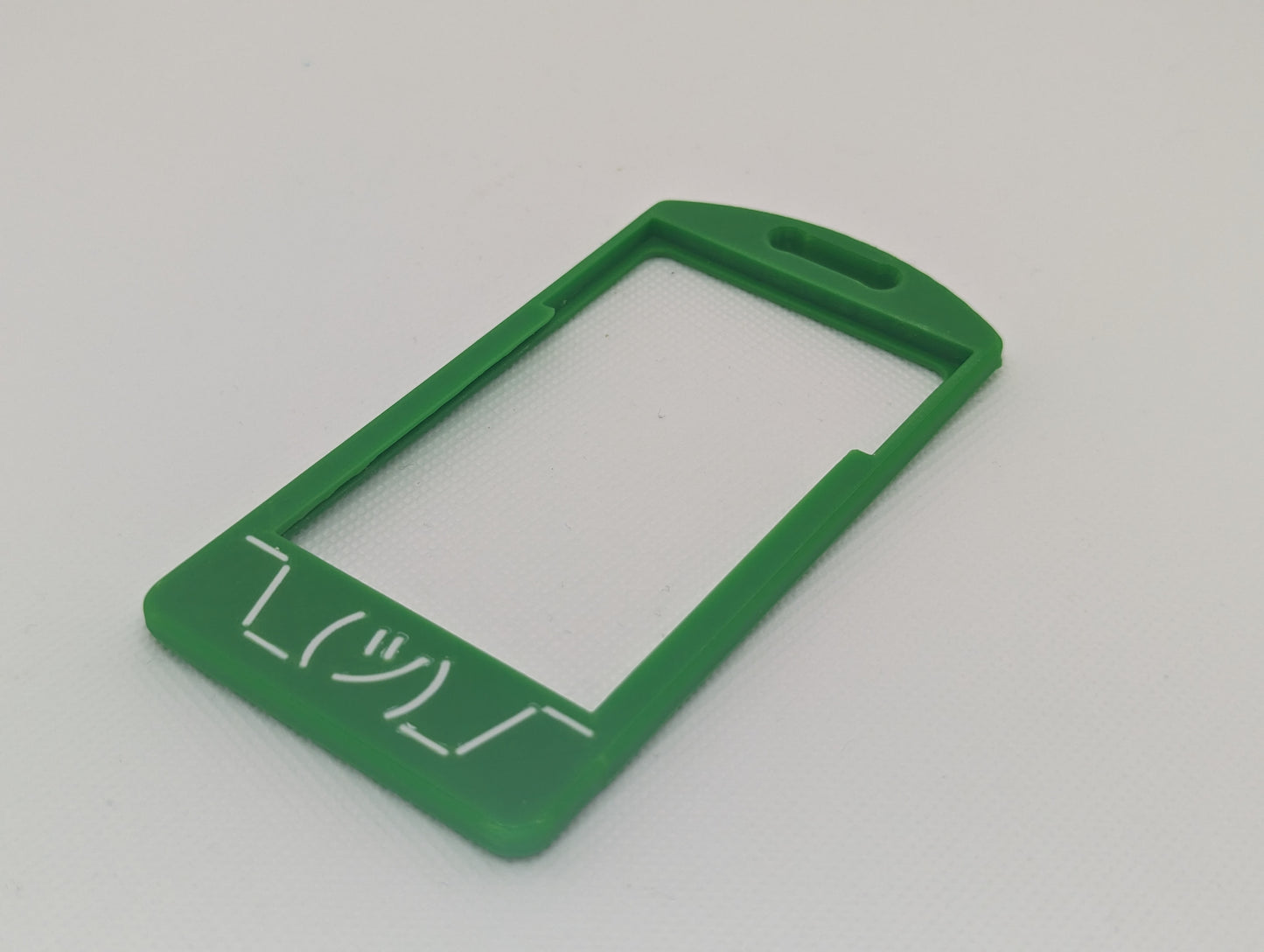 White shruggie flat on green badge